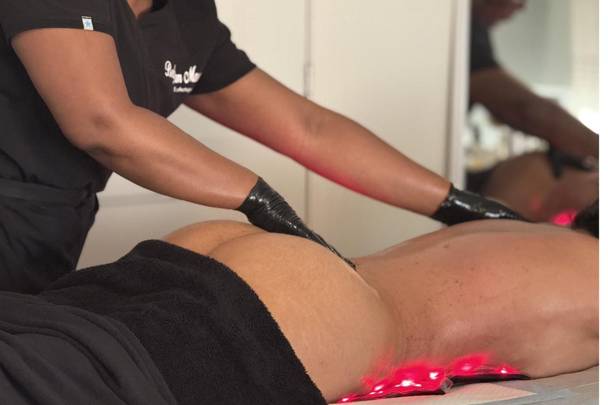 Séance de soin en cours : gants, uniforme brodé Body Dream Massage et bandeau de luminothérapie